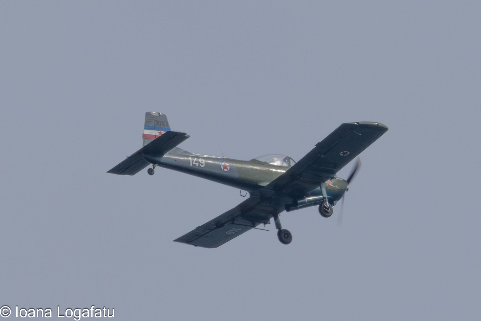 Vintage aircraft soaring through clear blue skies
